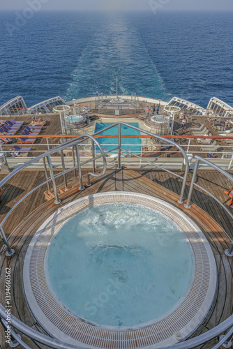 Obraz na płótnie Views onto outdoor teak balcony terrace veranda promenade sun pool deck of ocean liner cruiseship cruise ship with chairs loungers at sea during Transatlantic Crossing to New York on beautiful sun day w salonie