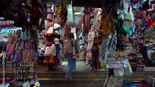 Young Woman Exploring Colorful Artisan Market in Aguas Calientes, Peru