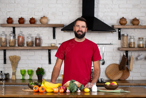 Portrait of young man preparing food in kitchen at home