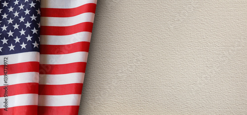 United States flag draped on a textured beige paper background. Symbolizing patriotism, freedom, and national pride. Perfect for memorials, holidays, or political themes with copy space.