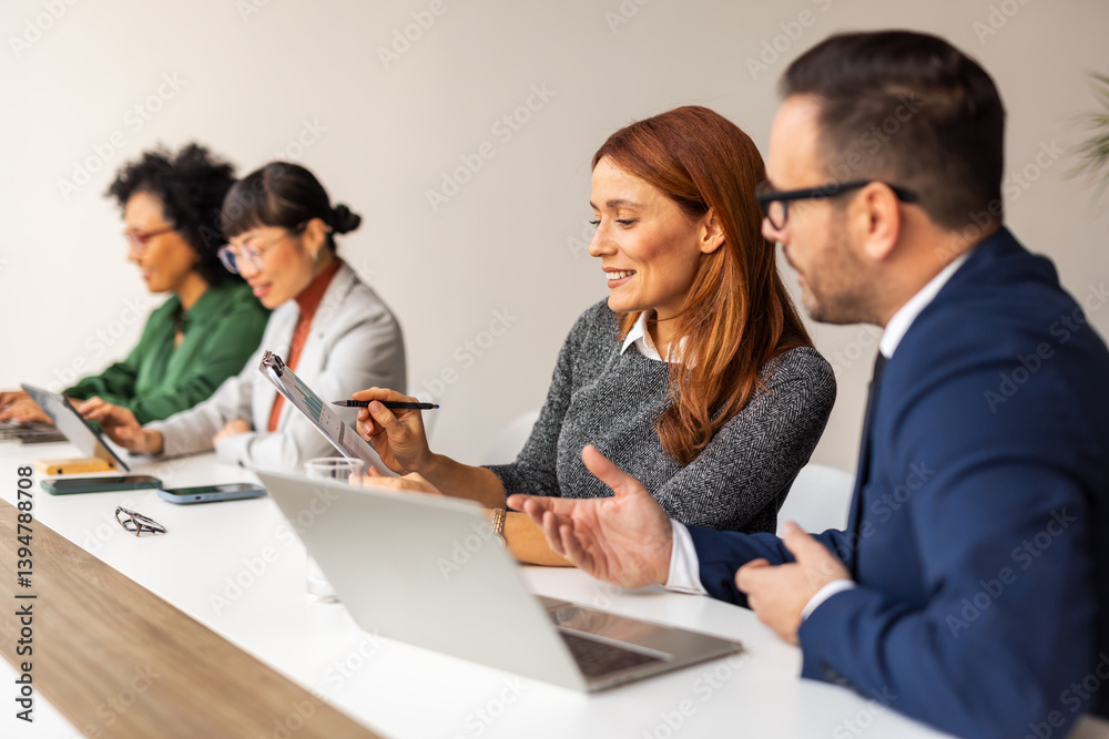 Team Collaborating in an Office Setting During a Business Meeting Team Collaborating in an Office Setting During a Business Meeting
