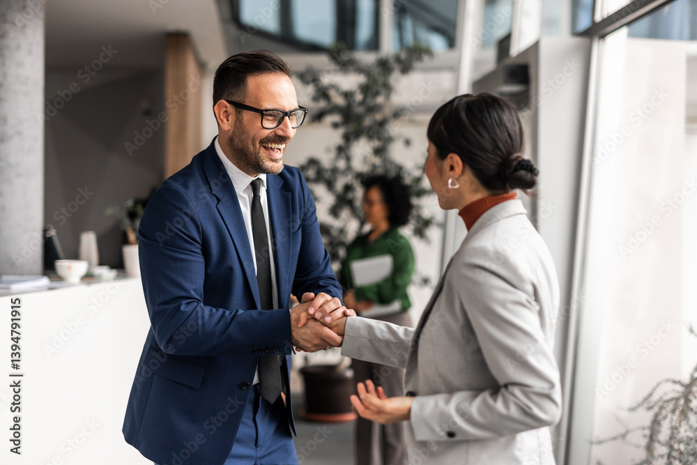 Business Colleagues Shaking Hands in a Modern Office Environment