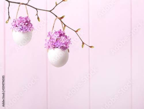 Obraz na płótnie Lilac flowers (Syringa) in eggsshells against a light pink background. Easter decor. w salonie