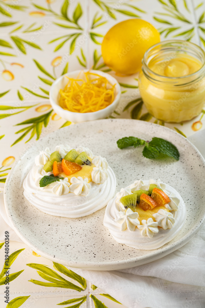 Lemon Curd and Berries Pavlova dessert on light colorful background. Vertical Lemon Curd and Berries Pavlova dessert on light colorful background. Vertical