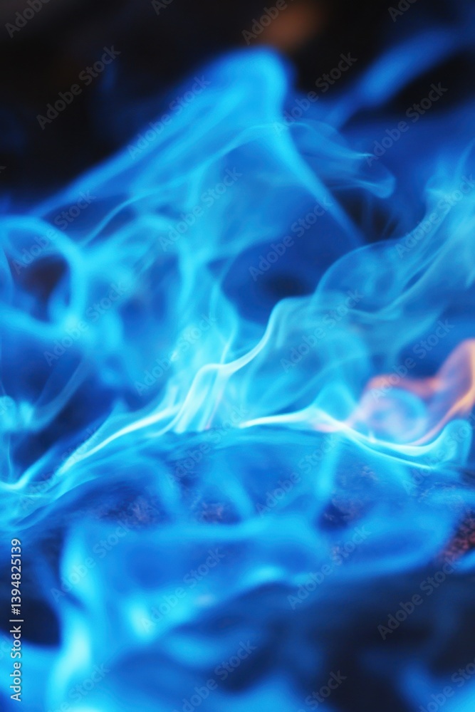 Fototapeta premium Captivating close up of vivid blue flames dancing above dark surface creating abstract ethereal patterns and mesmerizing visual effect