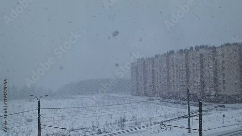 Winter landscape with a house during a heavy snowfall in the city.