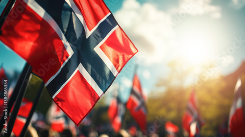 Norwegian flags waving energetically during national holiday celebration, filling blue sky with patriotic spirit while crowds gather joyfully in Oslo's streets