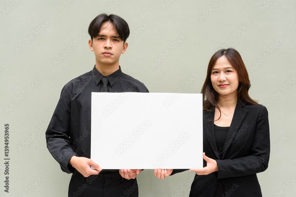 Portrait of young Asian couple wearing business uniform Portrait of young Asian couple wearing business uniform