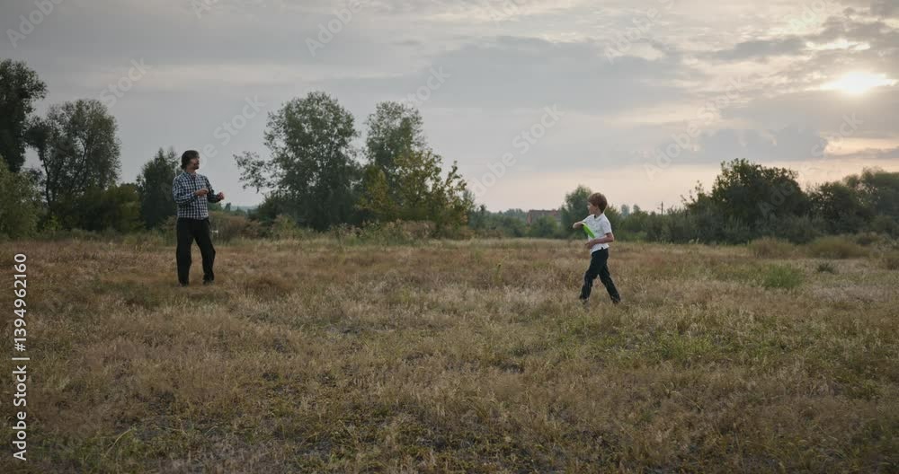 Man and Boy Throw Flying Disk. Dad and Child Play Together Spending Time on Nature 4K 10-bit Man and Boy Throw Flying Disk. Dad and Child Play Together Spending Time on Nature 4K 10-bit