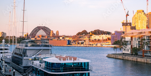 sunset at Pyrmont Bay wharf, with the Harbour Bridge at the horizon photo