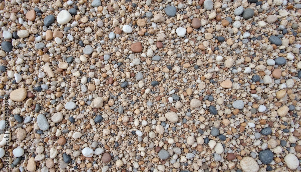 Vertical wallpaper made of multi colored beach stones. Background of colored pebbles. photo. Vertical wallpaper made of multi colored beach stones. Background of colored pebbles. photo.