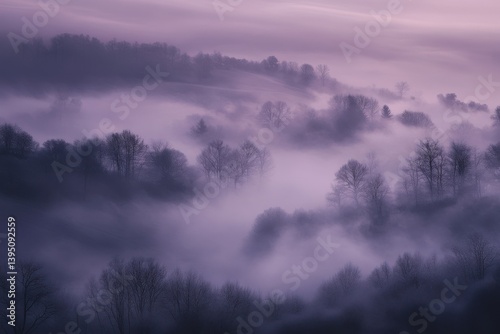 Dreamy mystical fog flowing over quiet purple hills and silhouetted trees in a tranquil twilight landscape

