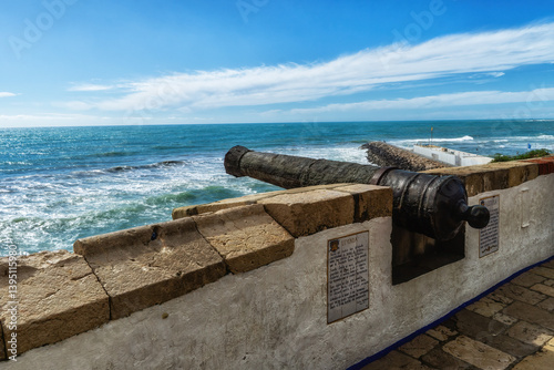 Huge cannon set into the wall overlooking the Mediterranean Sea at Sitges (near Barcelona) in Spain