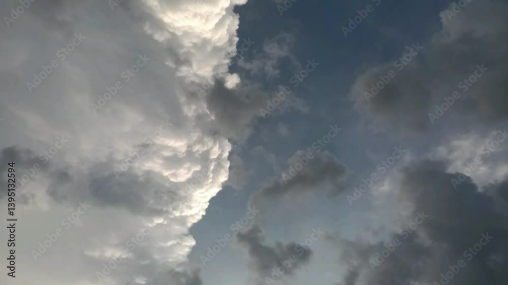 Dramatic Cloudscape Featuring Contrasting Light and Dark Clouds in Blue Sky Dramatic Cloudscape Featuring Contrasting Light and Dark Clouds in Blue Sky