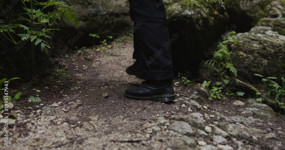 Russia, Caucasus. Persona walks along a narrow mountain path among the stones. Close-up footage of walking legs Russia, Caucasus. Persona walks along a narrow mountain path among the stones. Close-up footage of walking legs