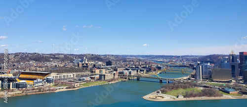 Pittsburgh, Pennsylvania, USA – April 10, 2024: Panoramic view of Point State Park where the Allegheny and Monongahela Rivers meet to form the Ohio River, with Acrisure Stadium and downtown in view.