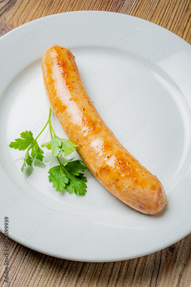 Grilled sausage on a white plate, garnished with fresh cilantro, is a culinary delight Grilled sausage on a white plate, garnished with fresh cilantro, is a culinary delight