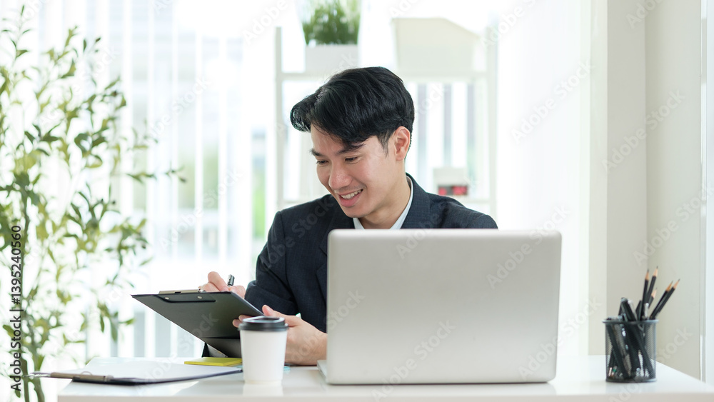 Businessman smiling while checking paperwork in a well-lit workspace. Businessman smiling while checking paperwork in a well-lit workspace.