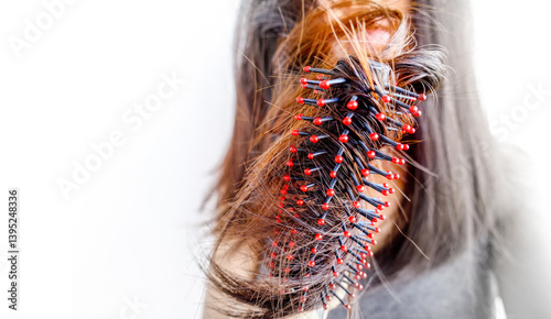 Closeup portrait of female model holding messy hair in hands, Combing with brush and pulls long hair, Daily preparation for looking nice, Long Disheveled Hair, Holding Messy Hair