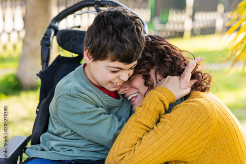 child with disability in wheelchair hugging mother in park