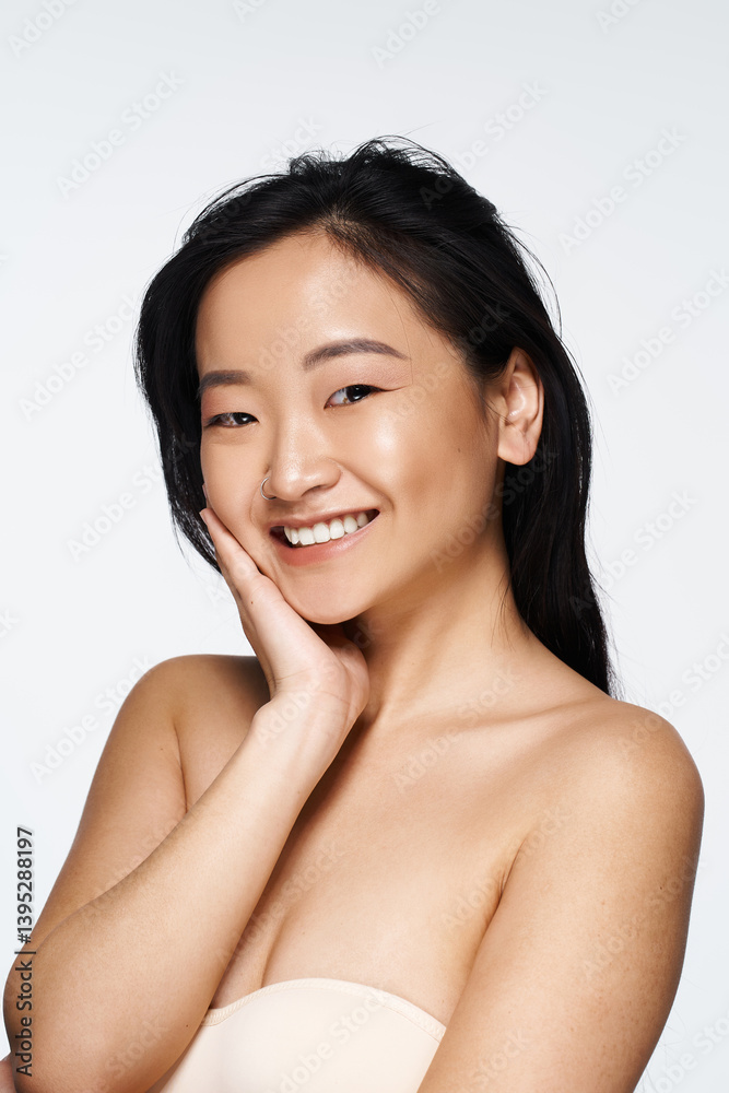 Capturing joy and beauty in a spontaneous moment of a young Asian woman smiling brightly Capturing joy and beauty in a spontaneous moment of a young Asian woman smiling brightly