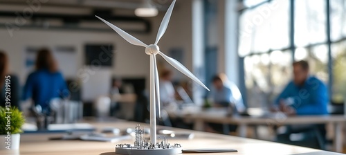 Obraz na płótnie Model of a windmill power station placed on an office desk in a naturally lit office room, symbolizing clean energy and smart workspace design. w salonie