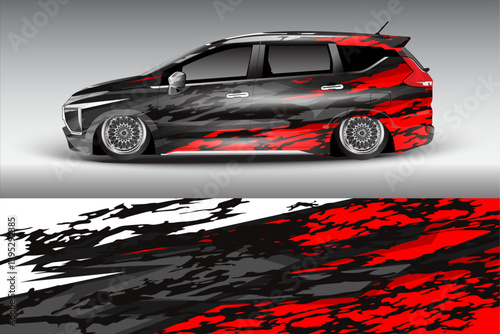 Stylish modified car with vibrant red and black graphics parked against a gradient background