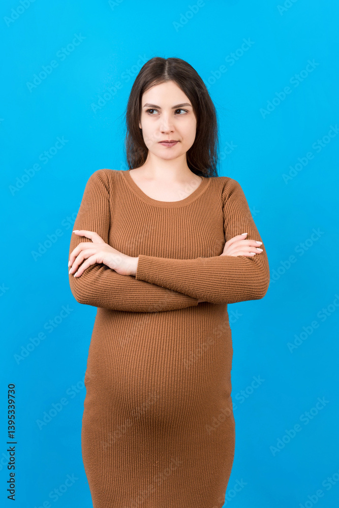 Pensive pregnant woman choosing name for baby on colored background. Dream and Happy Pregnant Woman Thinking Imagining Motherhood Life. Copy Space Pensive pregnant woman choosing name for baby on colored background. Dream and Happy Pregnant Woman Thinking Imagining Motherhood Life. Copy Space
