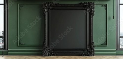 Obraz na płótnie A large, empty black frame with intricate carvings placed asymmetrically on a deep green wall, its ornate detailing contrasting elegantly with the modern background. w salonie