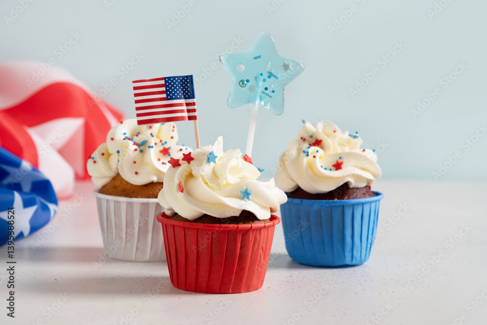 Traditional American three sweet cupcakes in white plate and USA flag on white background. Dessert for Patriotic Independence Day 4th of july.