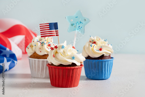 Obraz na płótnie Traditional American three sweet cupcakes in white plate and USA flag on white background. Dessert for Patriotic Independence Day 4th of july. w salonie