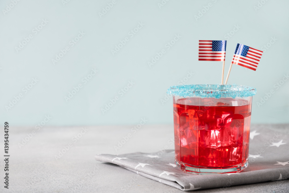 Patriotic red pomegranate margarita cocktail on blue background. Rim your festive beverages in blue sugar for popping for July 4th. Close up. Copy space.