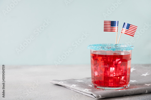 Obraz na płótnie Patriotic red pomegranate margarita cocktail on blue background. Rim your festive beverages in blue sugar for popping for July 4th. Close up. Copy space. w salonie