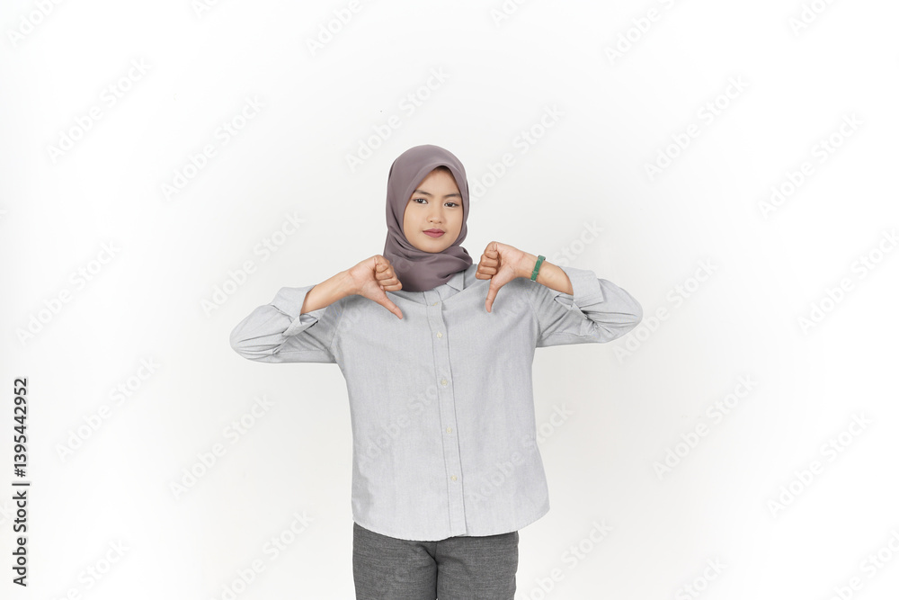 Showing thumbs down, disagree sign Of Beautiful Asian Woman Wearing Hijab Isolated On White Background