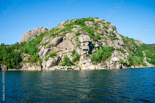 Obraz na płótnie Scenic Rocky Hill with Lush Greenery by a Calm Fjord, Stavanger, Norway, June 2018 w salonie