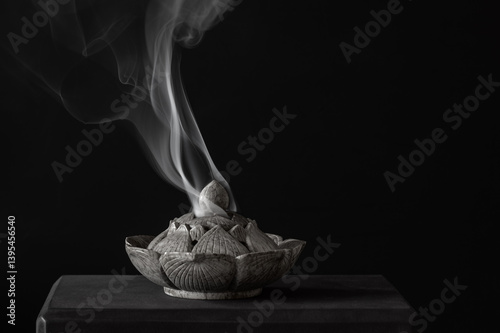 Photography Stone carved incense burner on a black background.