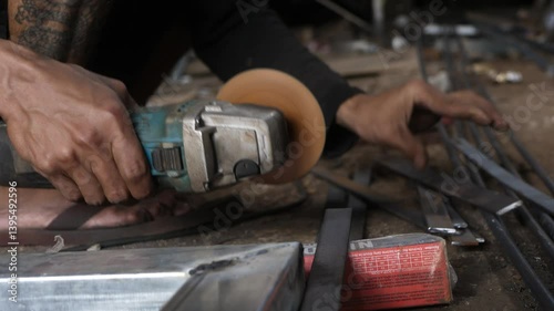 close up of man's hand grinding without using safety gloves. unsafe grinding work