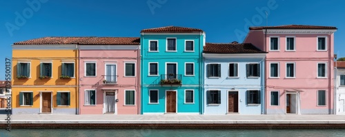 Brightly colored buildings lining a canal in Burano, Italy - houses town tourism quaint