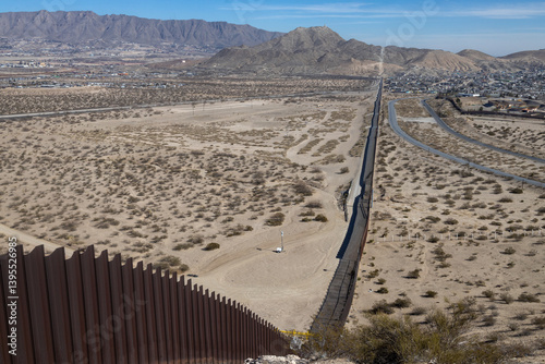 Aerial view of border wall and desert city