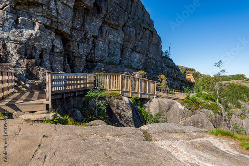 Obraz na płótnie Scenic Wooden Pathway Along Rocky Cliff on a Rocky Preikestolen Hiking Trail, Stavanger, Norway, July 2018 w salonie
