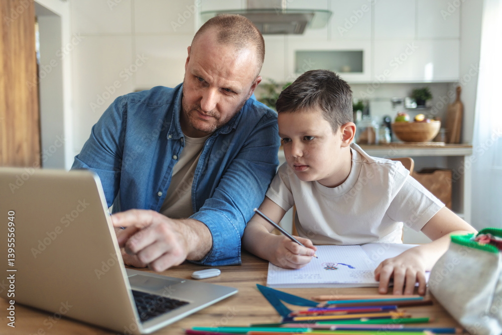Obraz premium Shot of a young father using a laptop while his son does homework at home