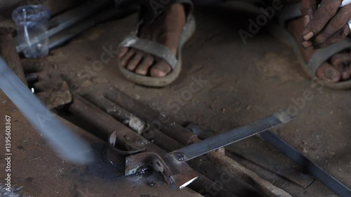 close up of hands bending iron without wearing gloves. unsafety work
