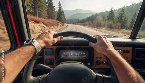Truck driver point of view holding steering wheel on scenic mountain road. Cabin view great for illustrating logistics, transport jobs or scenic driving experiences