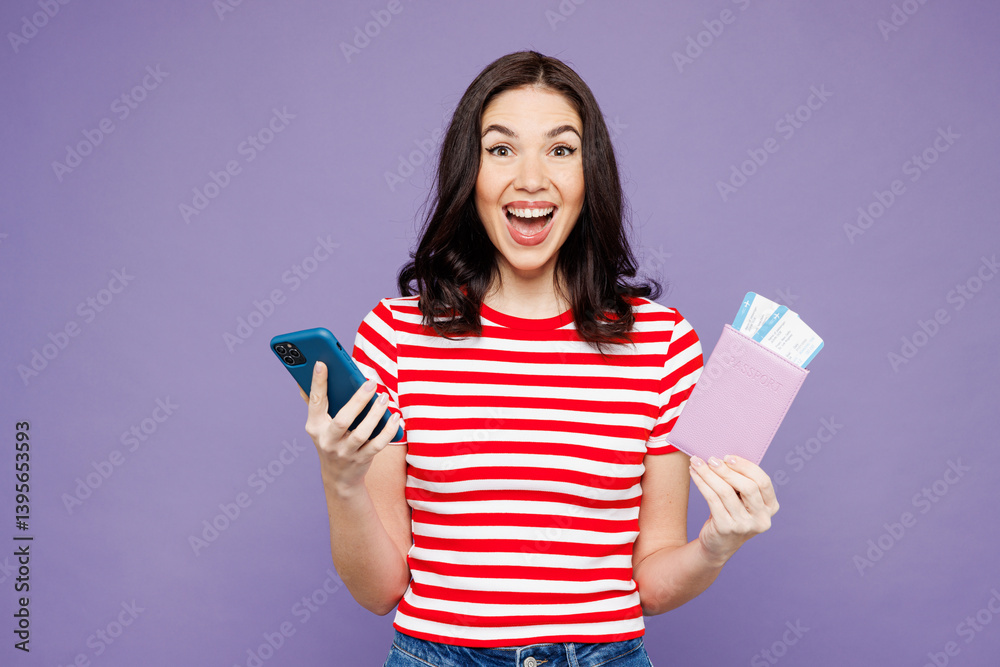 Traveler woman in red casual clothes hold passport ticket mobile cell phone isolated on plain purple background. Tourist travel abroad in free spare time rest getaway Air flight trip journey concept Traveler woman in red casual clothes hold passport ticket mobile cell phone isolated on plain purple background. Tourist travel abroad in free spare time rest getaway Air flight trip journey concept