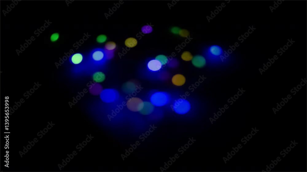 Abstract blue glows with bright, colorful bokeh lights in a festive design Abstract blue glows with bright, colorful bokeh lights in a festive design