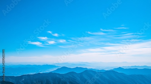 Serene Mountain Vista: A Breathtaking Panorama of Blue Hues Under a Vast Azure Sky