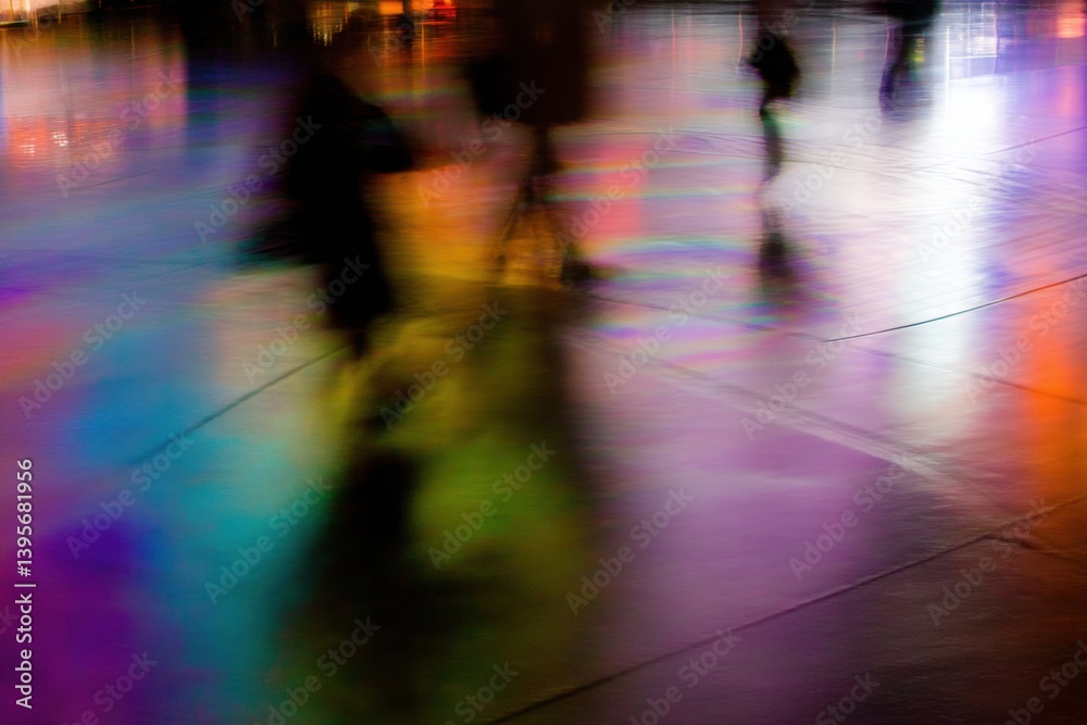 A vibrant, abstract scene shows blurred figures on a reflective, colorful surface, creating a dynamic interplay of light and shadow. A vibrant, abstract scene shows blurred figures on a reflective, colorful surface, creating a dynamic interplay of light and shadow.