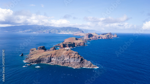 Mystical coastal landscape at the edge of the ocean showcasing rugged cliffs and vibrant blue waters in early daylight
