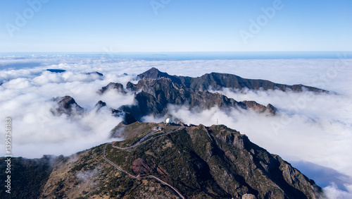 Majestic mountain landscape rising above clouds showcases nature’s serene beauty and atmospheric wonders at dawn