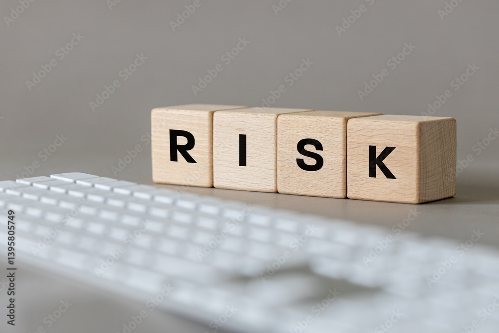 word Risk on wooden blocks and computer keyboard. Gray background. Concept, online safety. Inappropriate content. Online fraud
